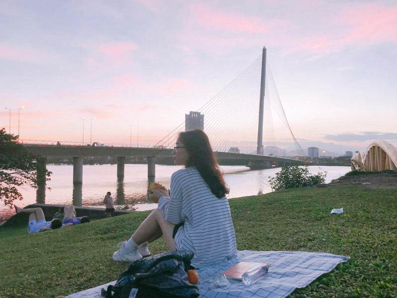 The grassy area near the foot of the bridge is an ideal spot for picnics and outdoor gatherings