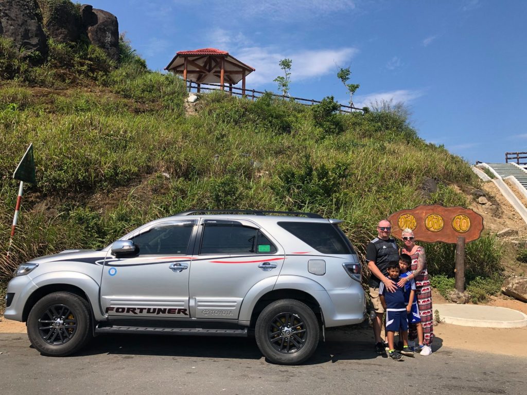 English-speaking driver picking up travelers in Hue for a private car journey to Quang Binh.