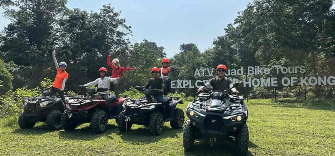 Tourists drive ATV off-road vehicles to explore the jungle