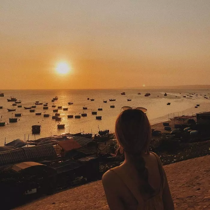 Tranquil sunset at a Nha Trang fishing village with rustic boats and calm waters