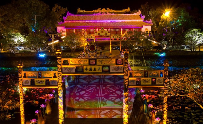 A breathtaking view of the Imperial City of Hue glowing with lights during the night.